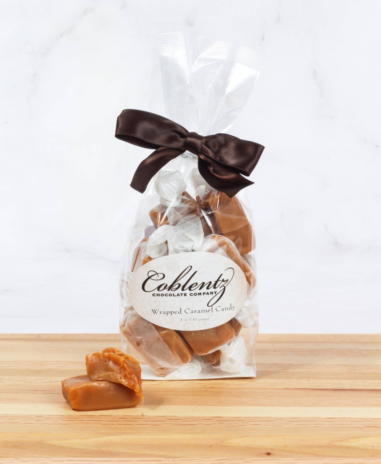 Wrapped caramel candy in bag with bow